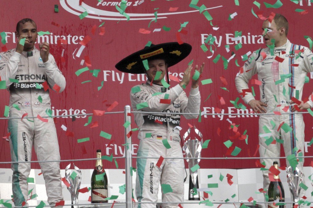 Nico Rosberg (centre) celebrates winning a colourful Mexican GP. Photo: Reuters