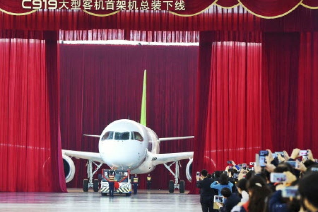 The first C919 passenger jet made by the Commercial Aircraft Corp of China (Comac) is pulled out during a news conference at the company's factory in Shanghai on Monday. Photo: Reuters