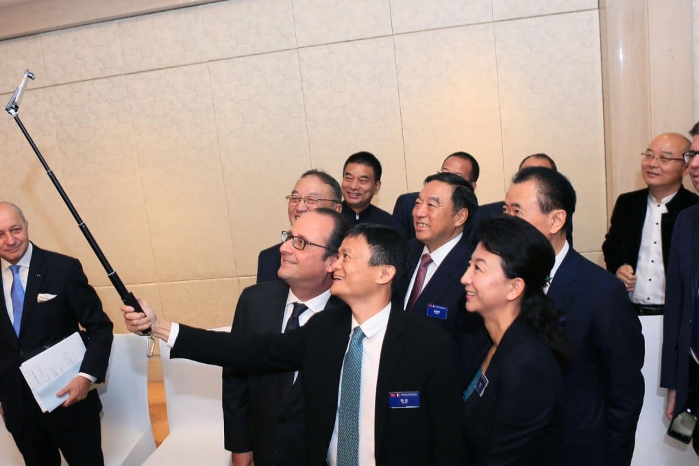 French President Francois Hollande (front, left) poses for a selfie with mainland entrepreneurs including Alibaba's Jack Ma.Photo: Xinhua