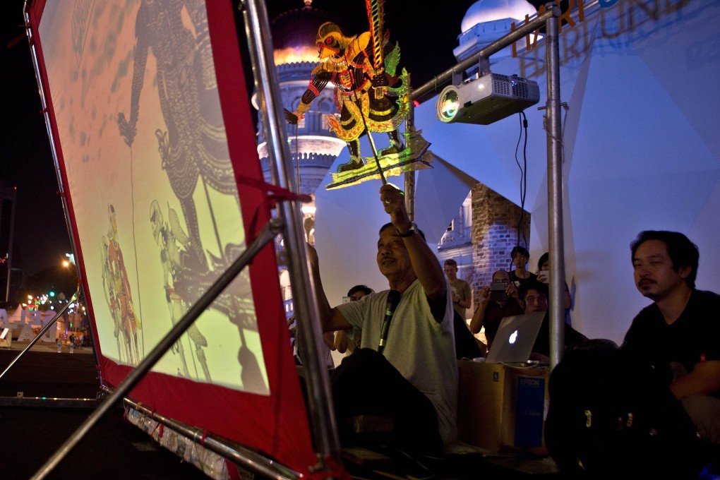 Master puppeteer Muhammad Dain Othman performs the "Star wars-inspired Wayang Kulit" , a traditional form of shadow puppetry.  Photo: AFP