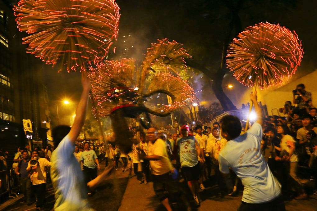 Dance of the fire dragon - traditional fire dragon dance brought the crowds as part of Mid- Autumn Festival celebrations. The 67-metre dragon wound its way through Tai Hang just as it has done since 1880 when the area was a Hakka fishing village. But while the tradition remains, Tai Hang itself is changing. Photo: Felix Wong