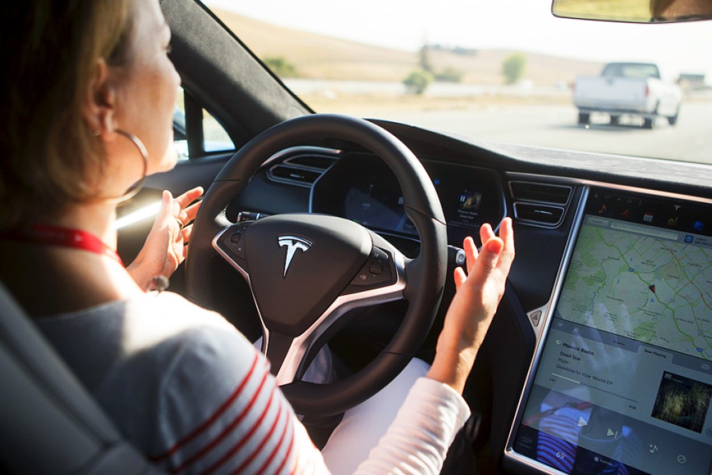 Look, no hands: An employee tests a Tesla Model S with Autopilot hardware and software. Photo: Reuters