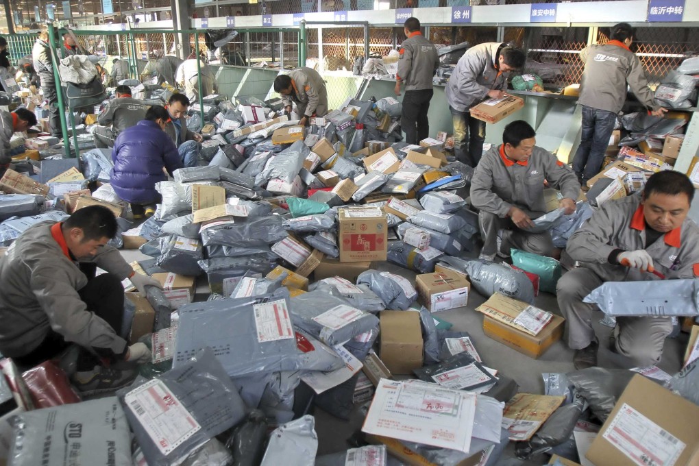 Workers sort out packages at an express delivery company in China's Jiangsu province. Photo: Reuters