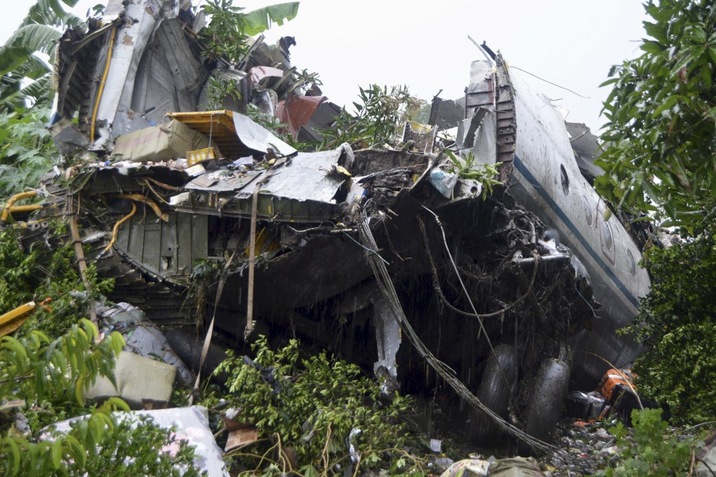 Parts of the plane were scattered in a bushy area populated with a few homes.  Photo: Reuters