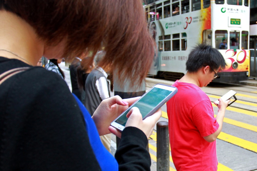 Smartphones now seem like an extension of our arm. Photo: May Tse