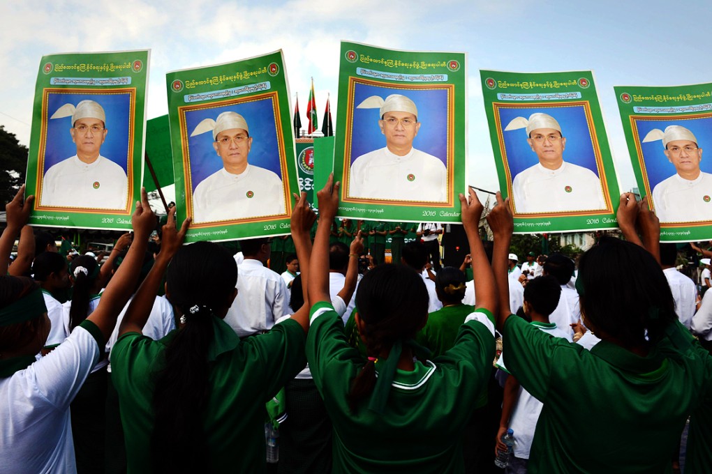 Supporters of the army-backed ruling Union Solidarity and Development Party (USDP) display portraits of Myanmar President Thein Sein during a campaign rally in Yangon. Photo: AFP
