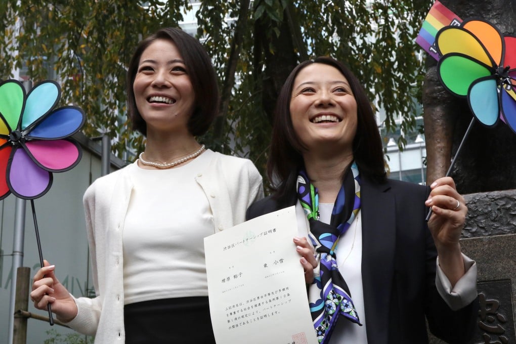 Japanese gay couple Hiroko Masuhara (right) and Koyuki Higashi display a certification paper of 'partnership' issued by the Shibuya ward office. Photo: AFP