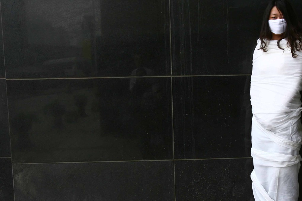 An activist stages a street art performance calling for greater women's rights in Beijing in a file picture. Companies might be reluctant to hire women who take advantage of existing protections, some women say. Photo: AFP