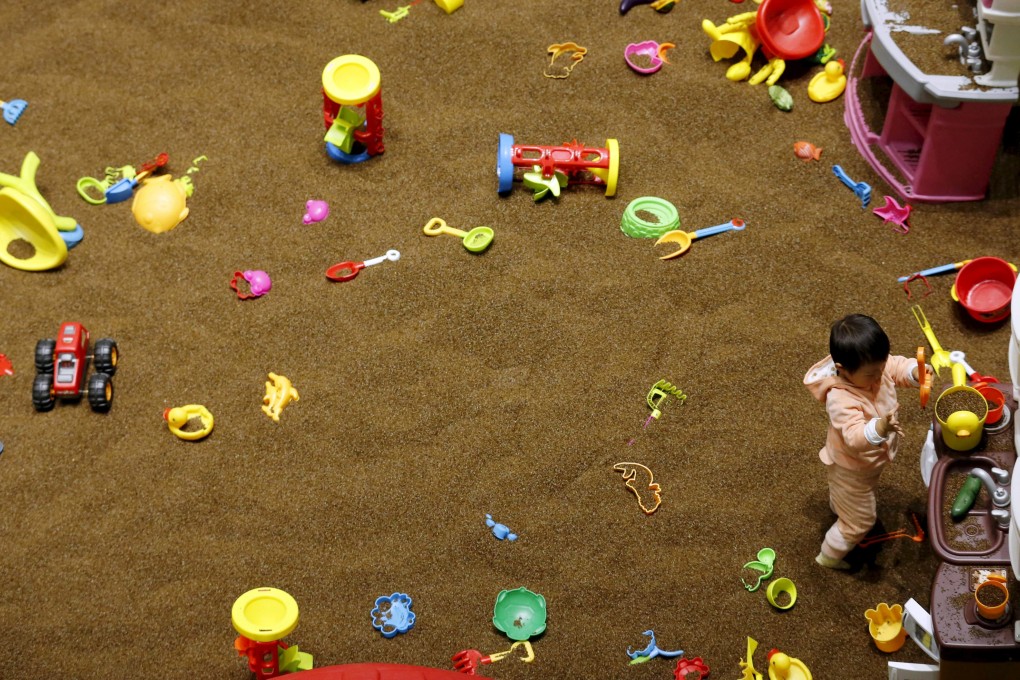 A two-year-old girl plays alone in Beijing. China has relaxed its one-child policy but fertility had been in decline since before the policy was put in place. Photo: Reuters