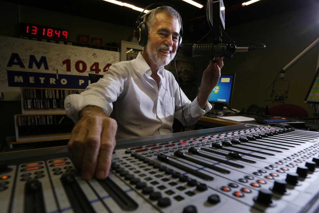 Bruce Aitken reaches out from his studio. Photo: Nora Tam