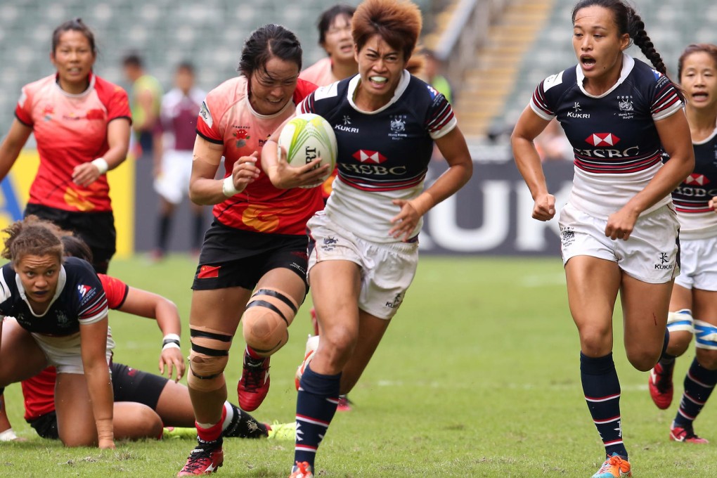 Hong Kong's Aggie Poon heads for the try line with captain Christy Cheng (right) in their clash against China at the Asia Rugby Sevens Qualifier at Hong Kong Stadium yesterday. The local side won the tense encounter 5-0. Photos: Edward Wong