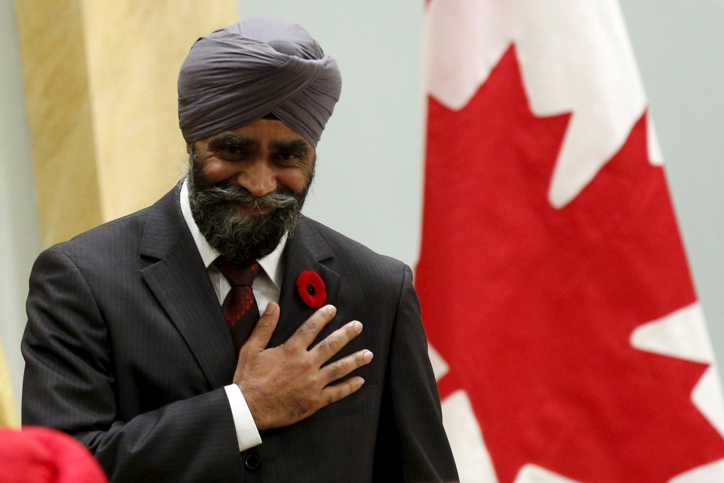 Canada's new National Defence Minister Harjit Sajjan being sworn-in during a ceremony at Rideau Hall. Photo: Reuters