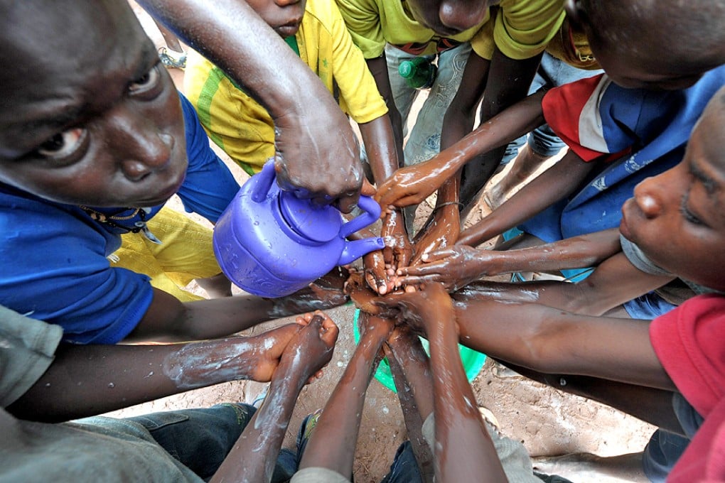 People washing their hands with soap and bleach to prevent the spread of the Ebola virus in Sierra Leone. The west African nation went 42 days without any new infections but should still be cautious as neighbouring Guinea still battling the virus. Photo: AFP