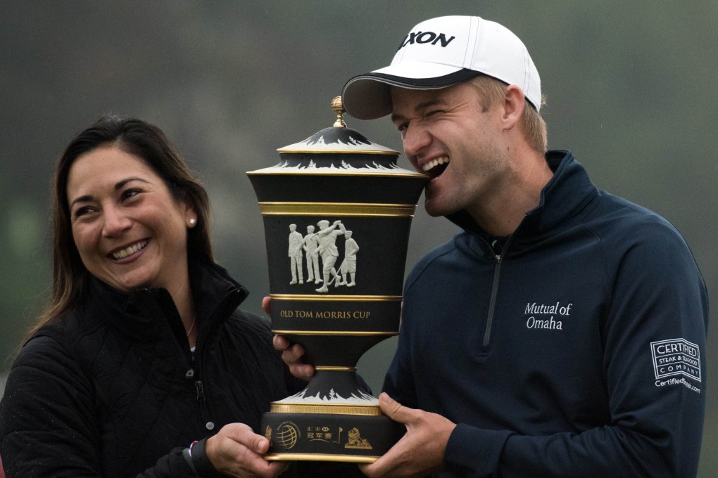 Russell Knox poses with his wife after winning the WGC-HSBC Champions in Shanghai. Photo: AFP