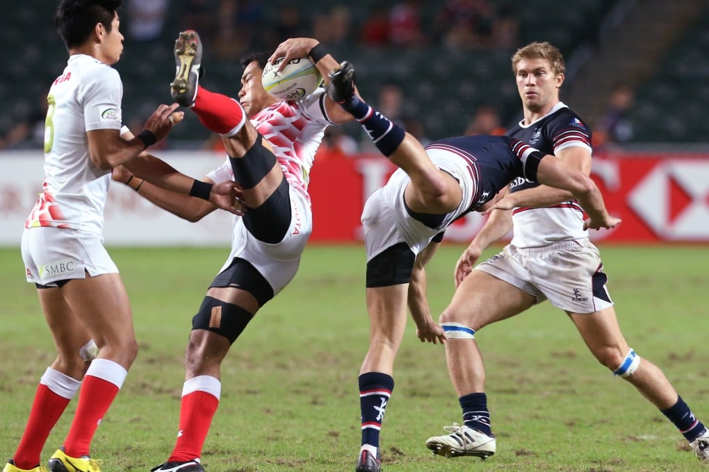 Hong Kong's Alex McQueen and Japan's Yusaku Kuwazuru are sent flying after a collision in the final of the Asia Rugby Sevens Qualifier at Hong Kong Stadium. Japan won 24-10 to earn a place at the Rio Olympics. Photos: KY Cheng/SCMP