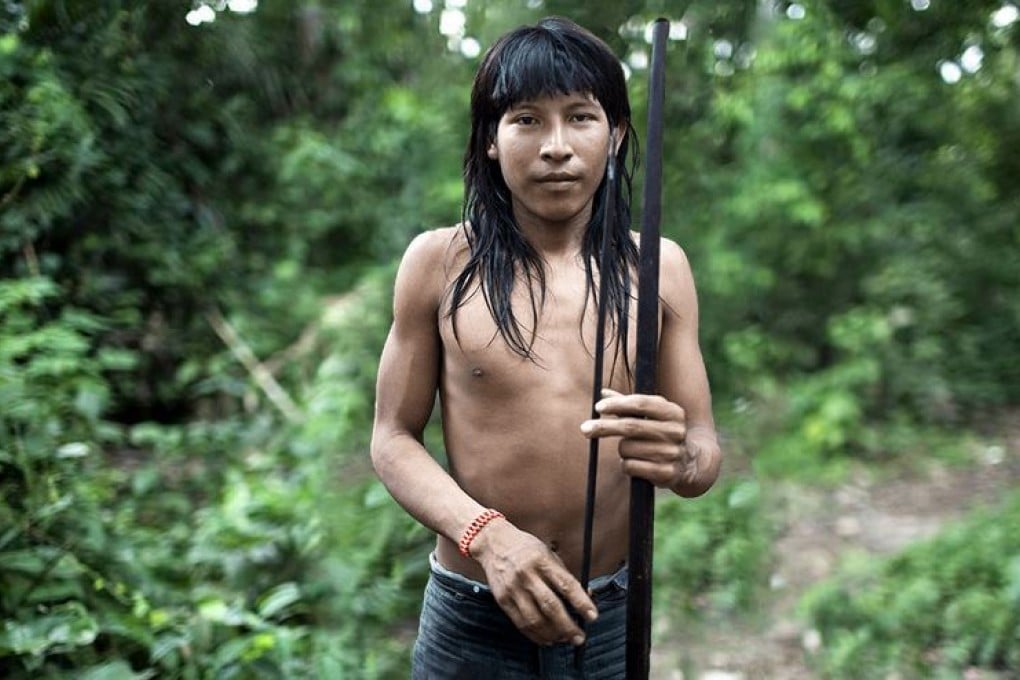 A young Awá tribesman is captured in a photo by the advocacy group Survival International. The group spearheaded a campaign to raise the alarm about the tribe's plight. Photo: Survival International.