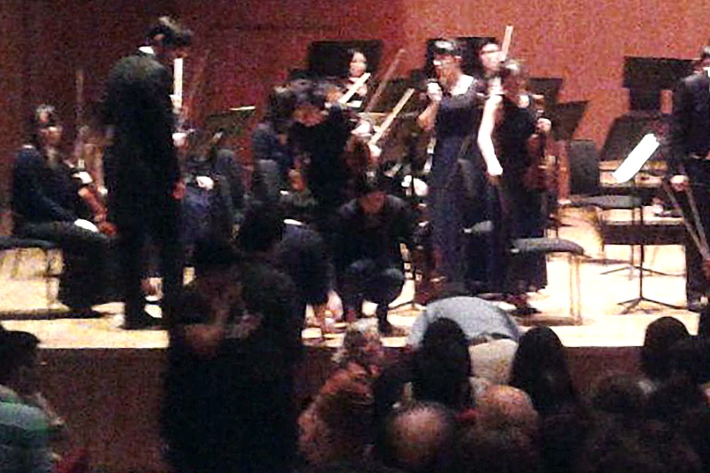 Audience shock as Hong Kong Sinfonietta concertmaster James Cuddeford falls from his chair to the floor after passing out during a concert at the City Hall Concert Hall on November 7, 2015. He was taken to Queen Mary Hospital on ambulance for treatment. Photo: Oliver Chou