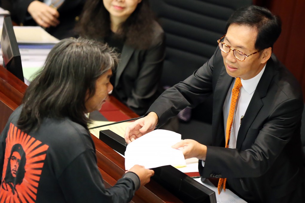 Legislator Leung Kwok-hung (left) talks to Legislative Council's Finance Committee Chairman Chan Kin-por (right) at the Legco meeting. Photo: David Wong