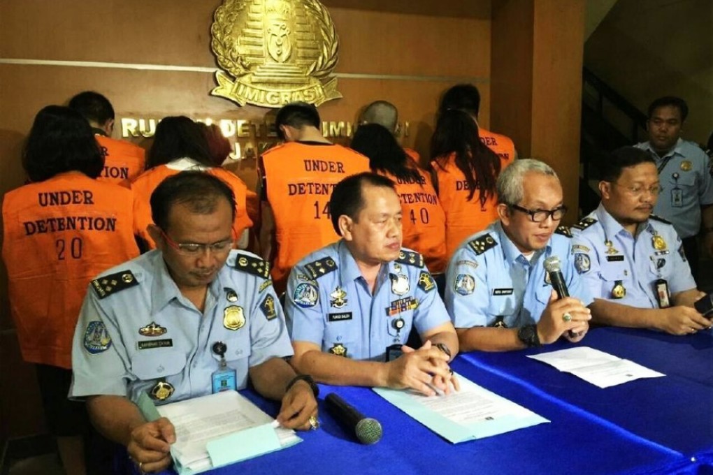 indonesian police sit in front of some of the detainees. Photos: SCMP Pictures