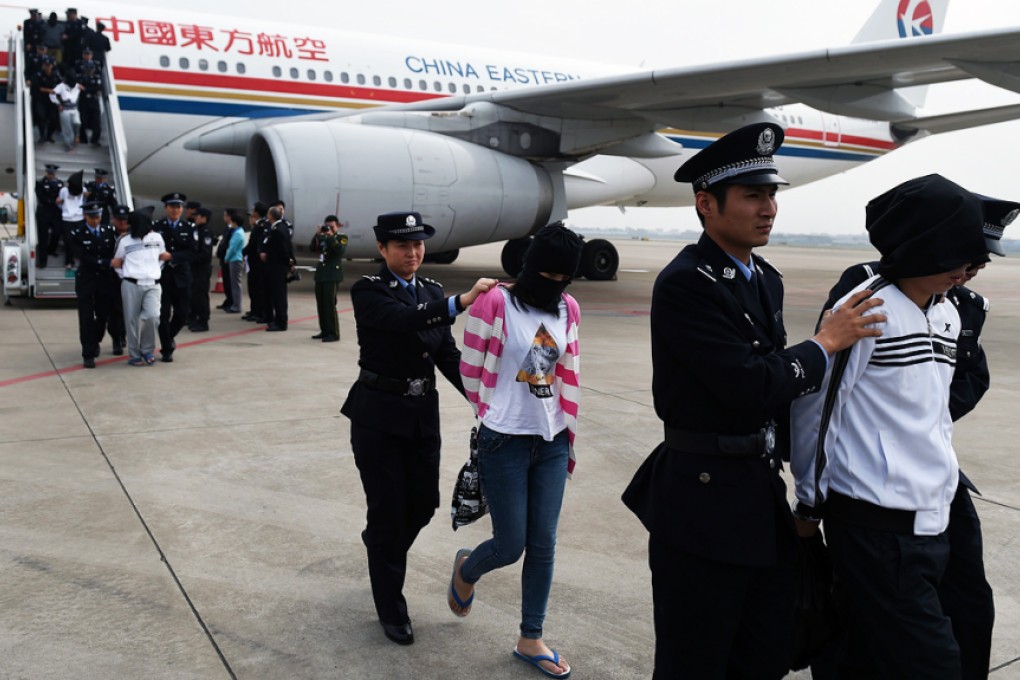 Suspects are escorted off an aircraft by police at Hangzhou airport in Zhejiang province. Photo: Xinhua