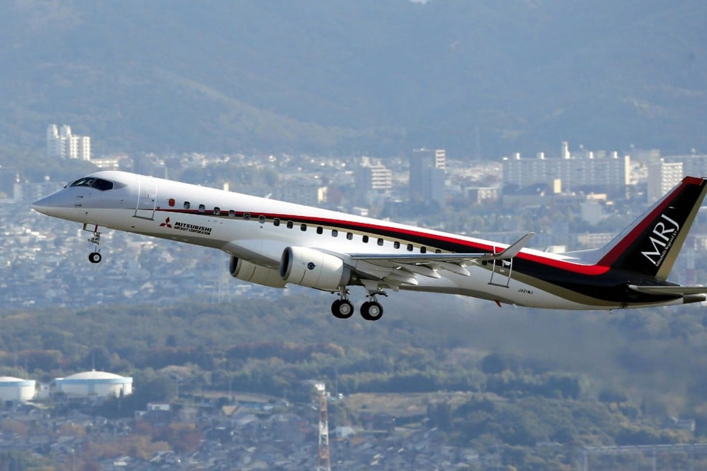 Japan's first domestically produced passenger jet, the Mitsubishi Regional Jet (MRJ), flying over the city of Komaki in the Aichi prefecture, central Japan. Photo: AFP