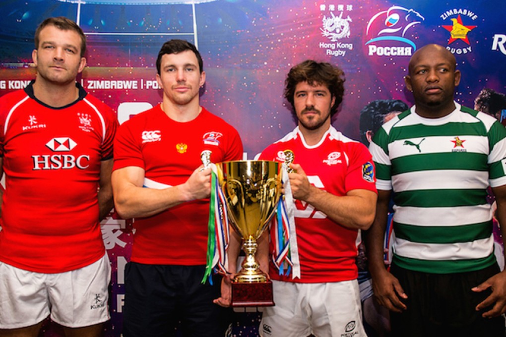 The captains of Hong Kong, Russia, Portugal and Zimbabwe pose with the Cup of Nations trophy. Photo: HKRU