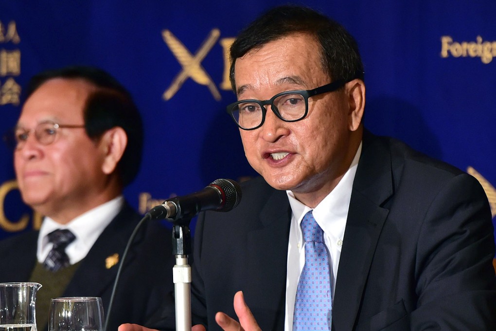 Cambodia National Rescue Party president Sam Rainsy (right) was sentenced in absentia to two years in jail and fined US$2,000 for defamation and incitement to provoke discrimination for remarks he made about the country’s foreign minister in 2008. Photo: AFP
