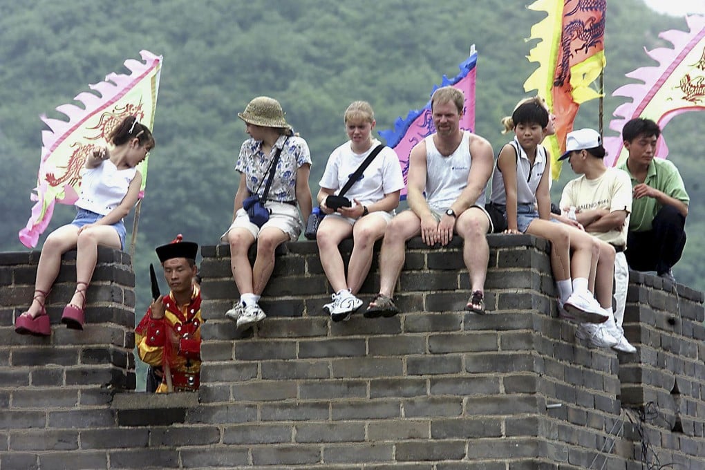 Foreign tourists at the Great Wall. China's historical sites are a big part of its draw for foreigners, a new report says.Photo: AFP