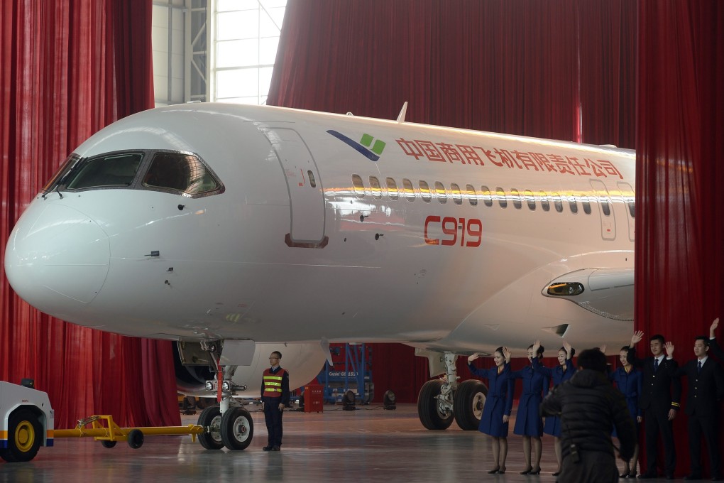 Workers roll out the first C919 passenger jet plane at the state-owned Commercial Aircraft Corporation of China in Shanghai. Photo: EPA