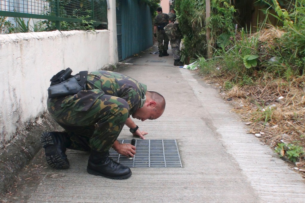 Police search Sun Fung Wai village for clues following the murder. Photo: SCMP Pictures