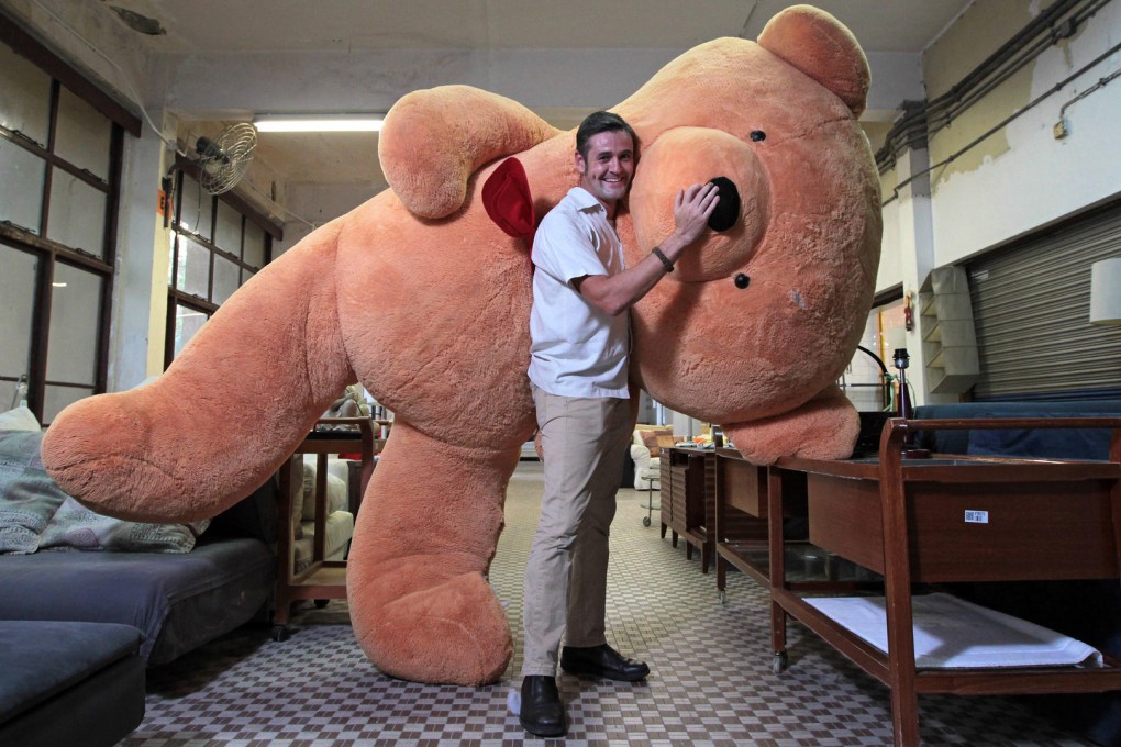 David Begbie from Crossroads Foundation poses with a giant teddy bear in the charity's headquarters in Tuen Mun. Photo: Bruce Yan