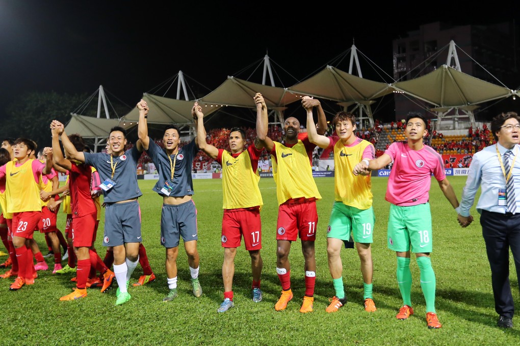 Hong Kong players and coach Kim Pangon celebrate after drawing against China in their World Cup qualifying soccer match in Hong Kong. Photo: Dickson Lee/SCMP