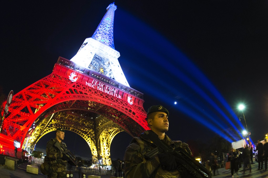 The Eiffel Tower is illuminated with the colors of the French national flag in tribute to the victims of the November 13 Paris terror attacks in which some 129 people were killed. Photo: AFP