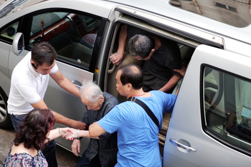 An elderly voter is taken to a polling station in Hung Hom. Photo: Robin Fall