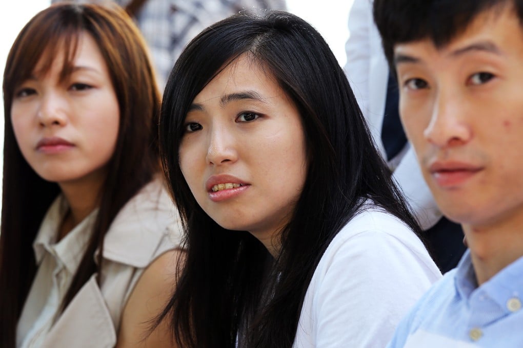 Kwong Po-yin (centre), of the newly formed group Youngspiration, defeated Kowloon City council chairman Lau Wai-wing in another shock victory for the umbrella movement. Photo: Dickson Lee