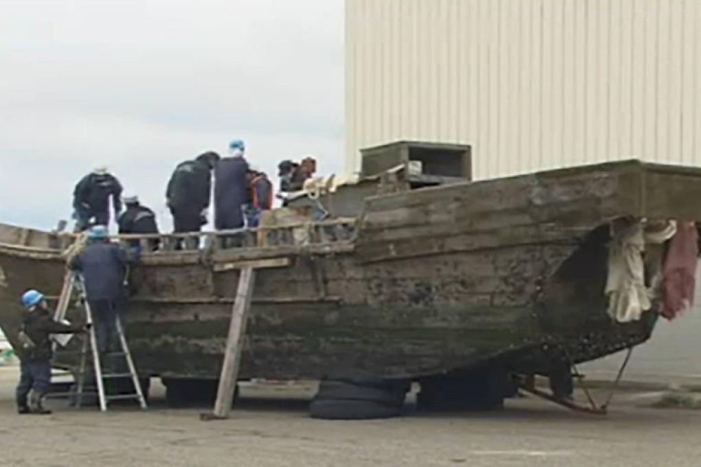 Japanese officials inspect a North Korean fishing boat.