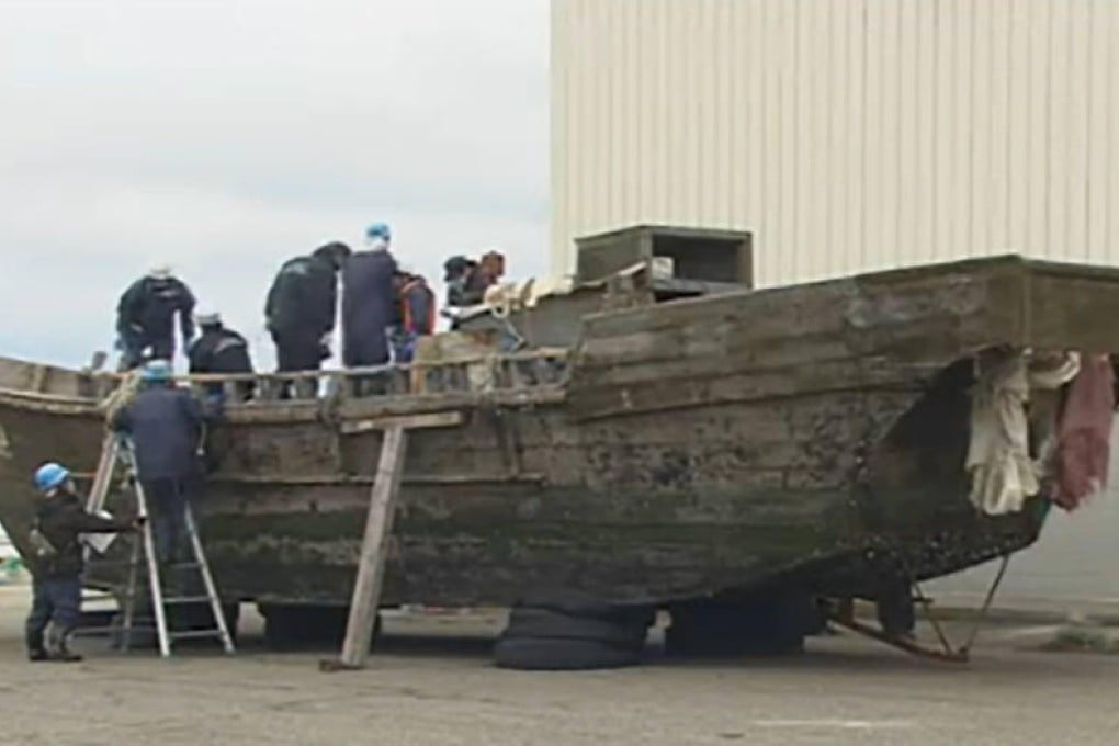 Japanese officials inspect a North Korean fishing boat.