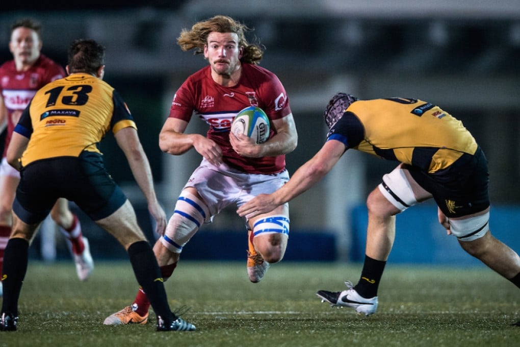 Kowloon and Hong Kong flanker James Cunningham spots a gap in the Tigers defence. Photos: HKRU