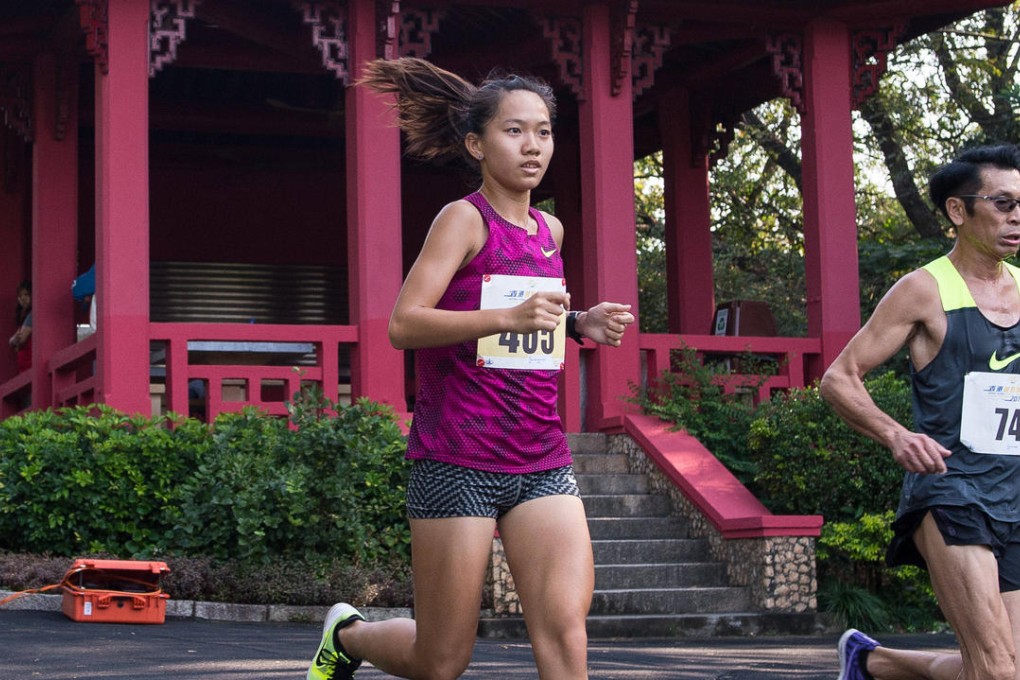 Taiwan runner Chang Chih-hsuan passes the historic half-way house on the Old Course in the Lucozade Hong Kong Cross Country Championships. Photo: Richard Castka/Sportpix International