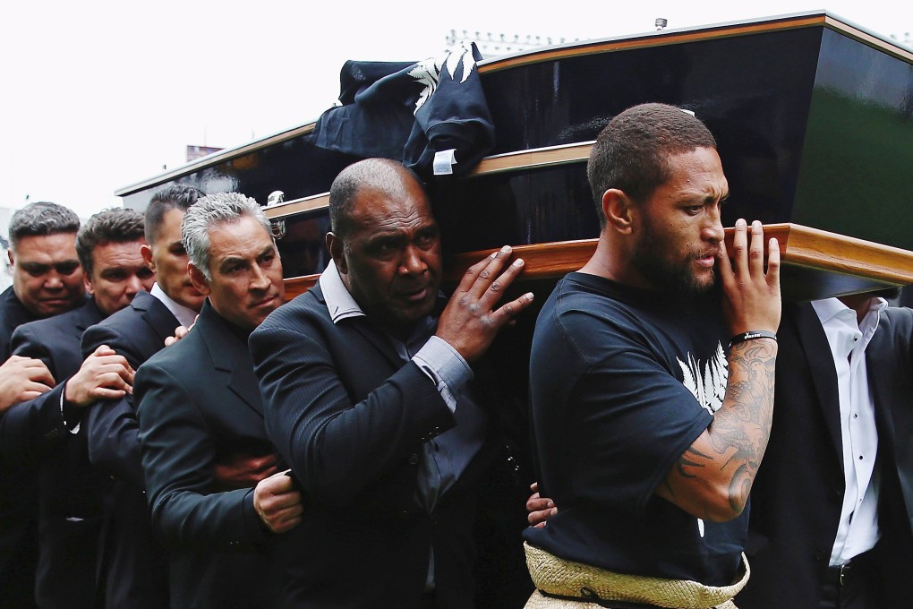 An official party carries the casket of former All Blacks player Jonah Lomu during a memorial service at Eden Park. Photo Reuters