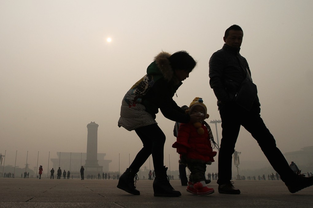 Pedestrians walk pass by Beijing's Tianamen Square as smog persisted in northern China for a second day. Photo: Simon Song