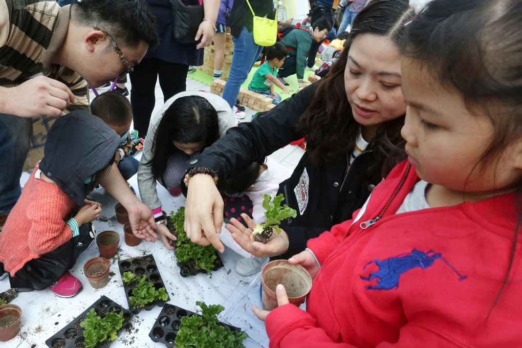 Parents and their kids plants outside Legco Building in Tamar while staging a protest against Territory-wide System Assessment. Photo: Jonathan Wong