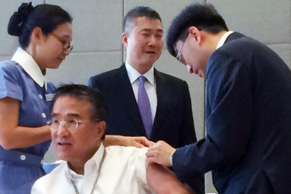 Dr Ko Wing-man gives Michael Tien a flu jab. Photo: Jeffie Lam