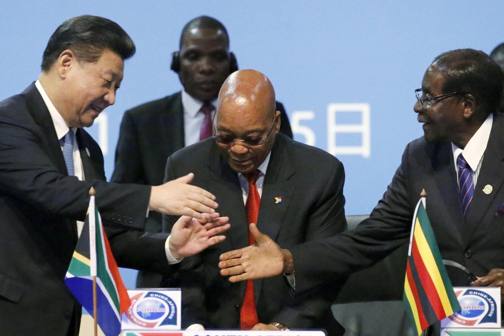 President Xi Jinping shakes hands with Zimbabwe President Robert Mugabe as South Africa's President Jacob Zuma looks on. Photo: Reuters