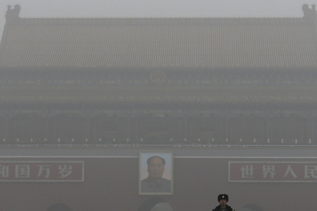 Smog shrouded the Tiananmen Gate in Beijing even as China touted its "green progress". Photo: AP