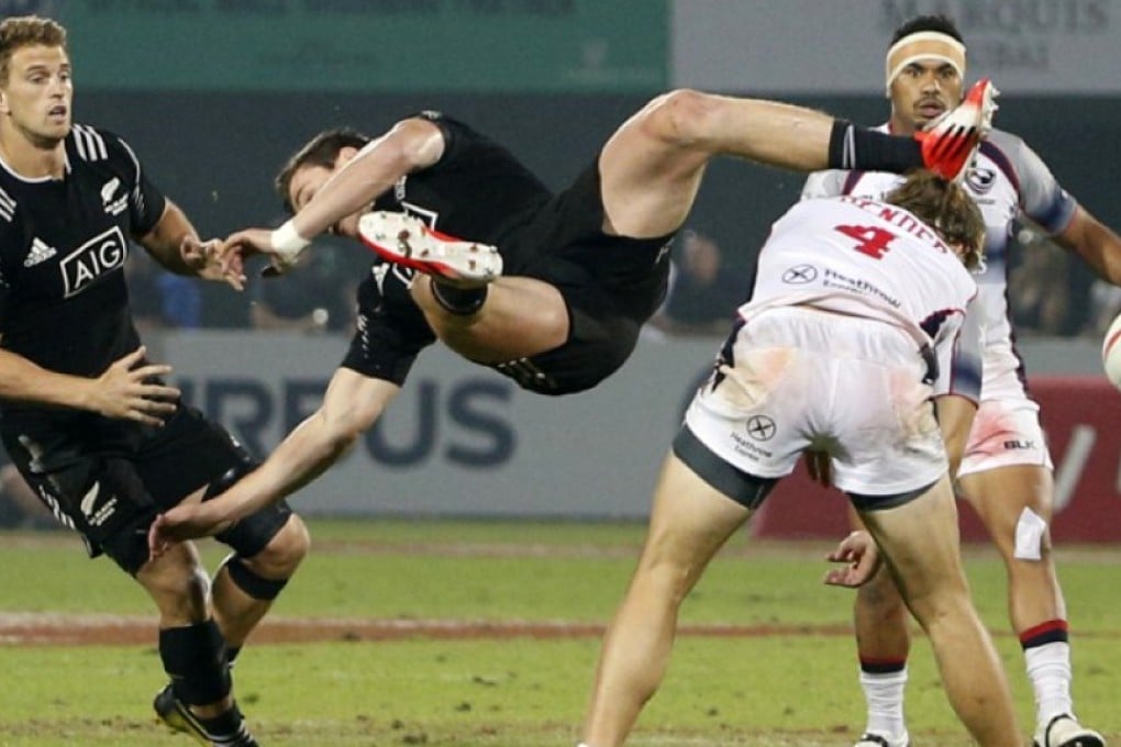 Sam Dickson of the All Blacks Sevens gets upended as he fights for the ball with USA player Garrett Bender during their pool game on the first day of the Dubai Sevens. The American won the match 14-12. Photos: AFP