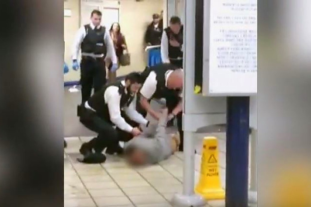 Police pin the knife attacker to the ground after he has been Tasered. Photo: AP