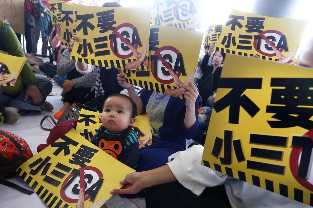Concern Group and parents hold placards and protest against Territory-wide System Assessment outside Legco Building in Tamar. Photo: Jonathan Wong