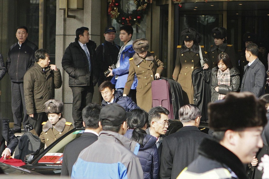 Members of the Moranbong Band leave a hotel in central Beijing on Saturday, hours before they were due to take the stage. Photo: Reuters