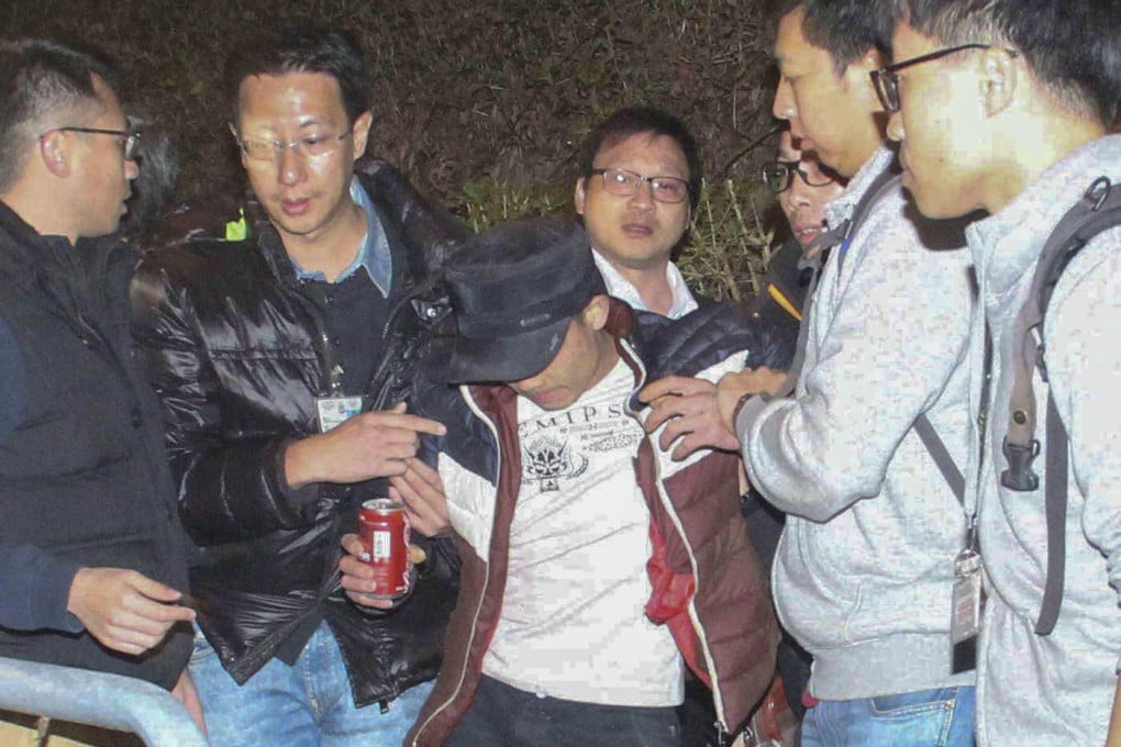 One of the robbery suspects is detained.Photo: SCMP Pictures